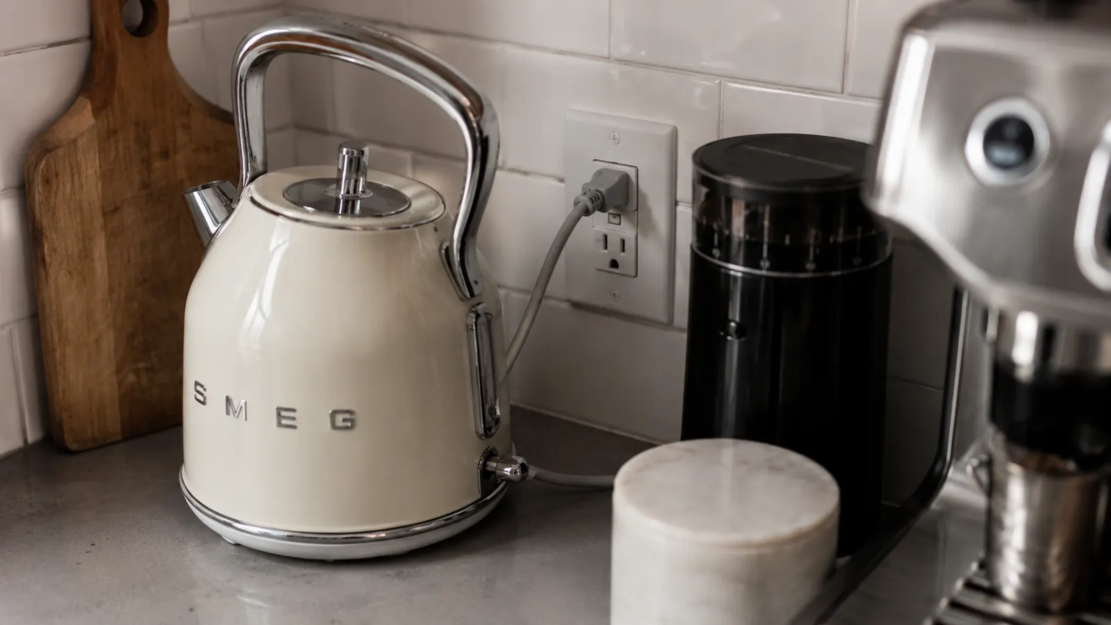 Short power cord from the kettle base reaching to a nearby outlet on a tight counter layout